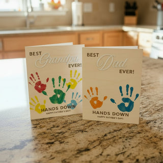 Two wooden cards with Father's Day messages on astone suface
