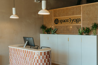 rattan wall in calm lobby with logo and tile stone pos check out