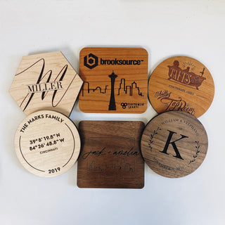 range of custom coasters in different wood types with a multitude of engraved designs 