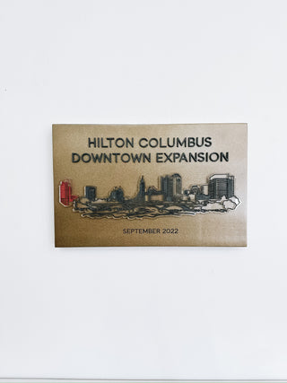 custom gold acrylic plaque for hilton columbus downtown expansion with raised acrylic city skyline