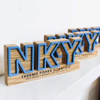 oak hardwood awards in the letters "NKY", raised blue outline, engraved lettering details