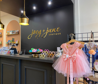acrylic interior signage business name in script with a shiny gold surface