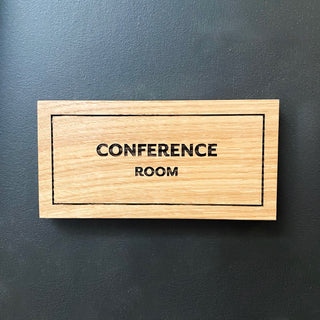custom wayfinding rectangular wood sign with engraved "conference room" and outline border