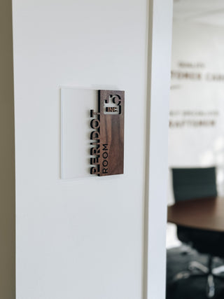 wayfinding sign made of frosted acrylic combined with walnut wood, negative and positive space lettering