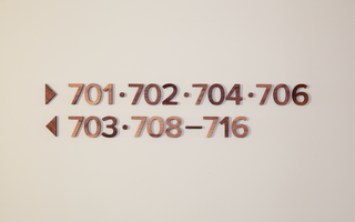 floating numbers made from wood with directional arrows 