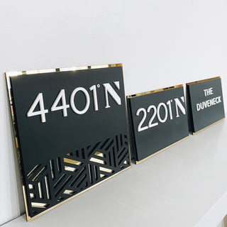 wayfinding signs black acrylic with gold outline, raised white text and cut out design