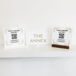 custom wayfinding white acrylic sign with gold filled lettering "the annex"