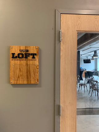 custom wayfinding wood sign with black lettering and acrylic photo holder