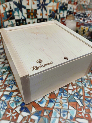 custom wood box with sliding top and company name and logo engraved in corner