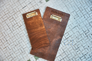 Custom wood board with gold clip for restaurant menu, etched business name on top 