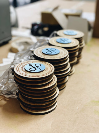 custom wood ornaments with layered company logo and engraved details