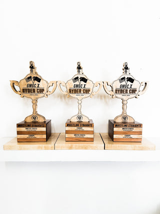 custom wood trophy shaped memento with layered and engraved details on wood block base 