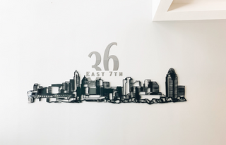 large scale installation of the cincinnati skyline with a building address above 