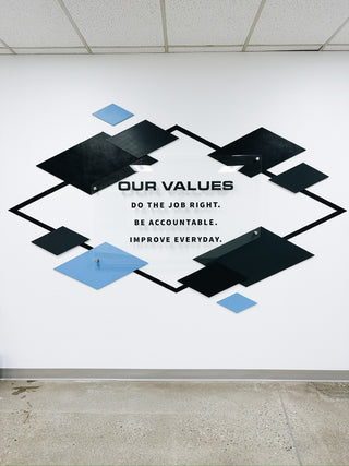 large scale installation of a diamond outline with smaller blue and black surrounding diamonds, mission statement in the middle