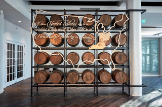 large scale installation of a thin usa outline with kentucky and ohio shapes and floating script in center