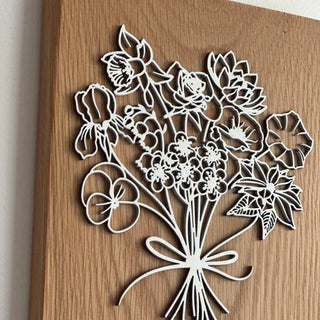 close up of personalized floral birth month plaque w/ oak wood + white painted birch wood